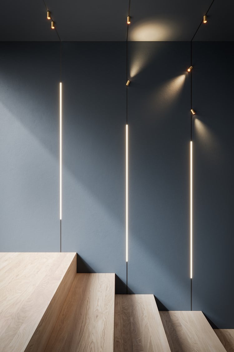 Linear trimless track lighting in the wall and ceiling in a wooden staircase