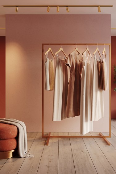 Track lighting in champagne highlighting clothes in commercial space