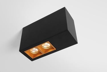 Black surface box light with a gold accent around the led light