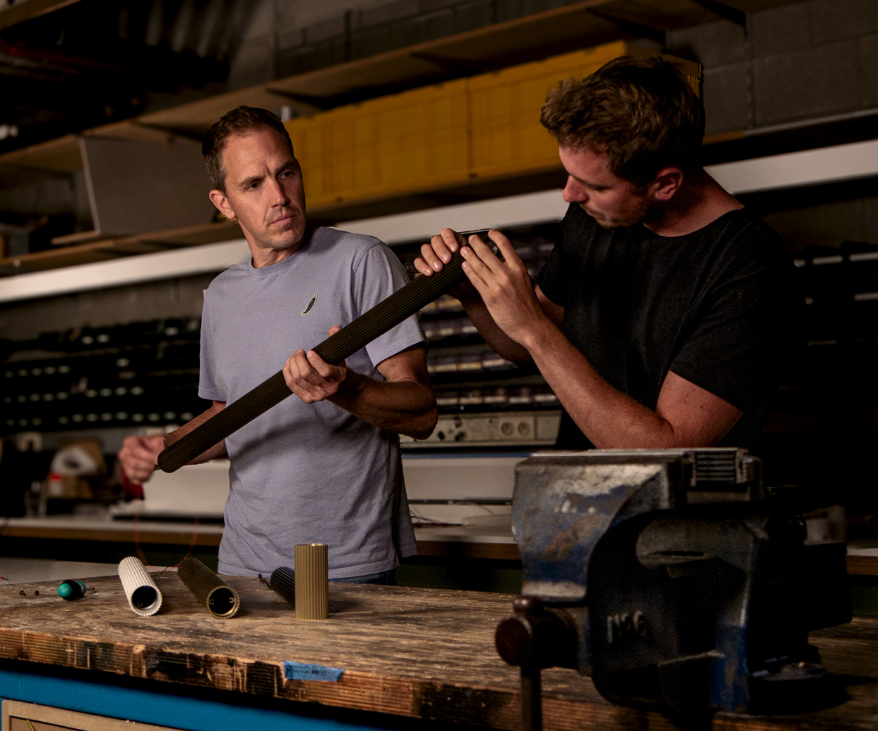 engineers working on extruded stripped pendant luminaire