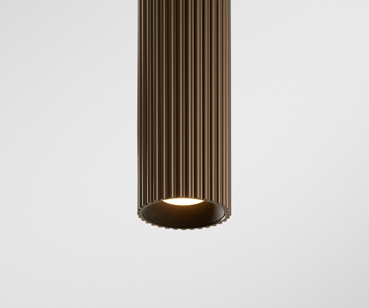 extruded stripped pendant luminaire ribbed in bronze brushed anodised