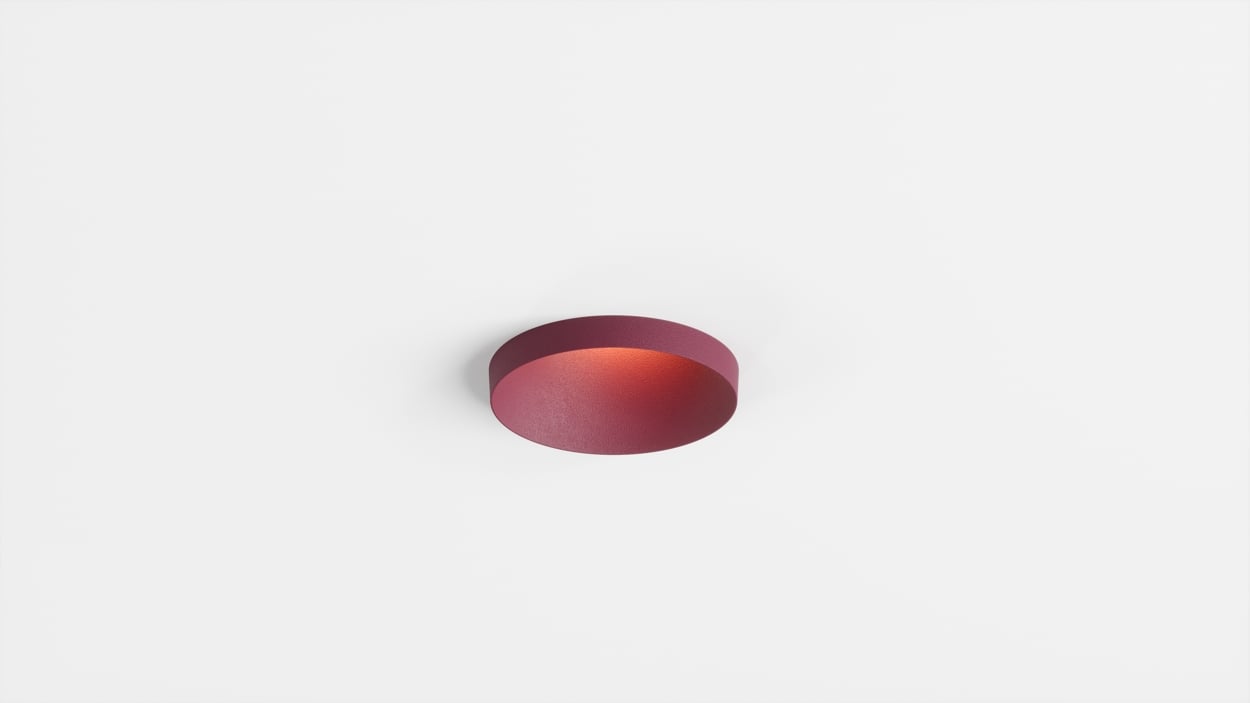 Close-up of Kup, a round recessed spotlight with a custom RAL4004 finish and distinctive raised edge.