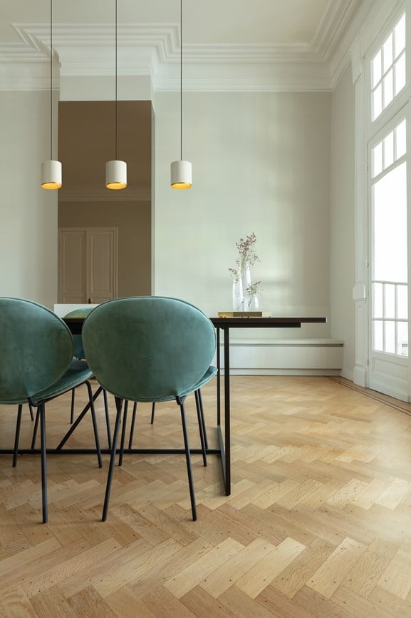 Cylinder-shaped pendant lighting above dining table